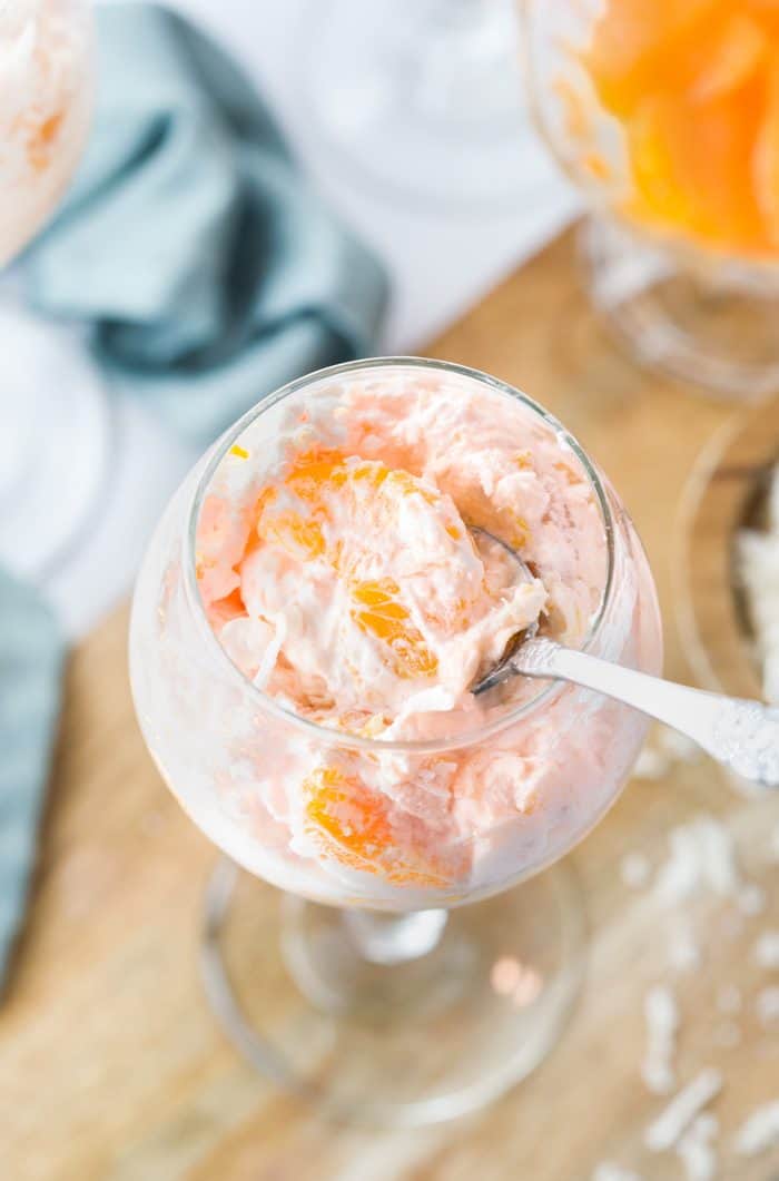This creamy orange fruit salad is loaded with an easy combination of mandarin oranges, crushed pineapple, coconut flakes, and an orange-flavored cool whip mixture that's topped with maraschino cherries. Fruit Salad with Cool Whip