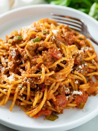 A white plate topped with One Pot Spaghetti in meat sauce.