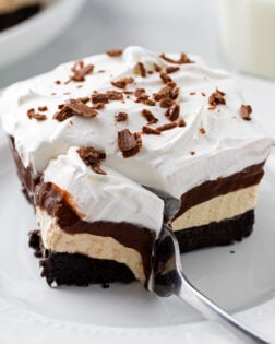 A fork cutting into a slice of Peanut Butter Delight.