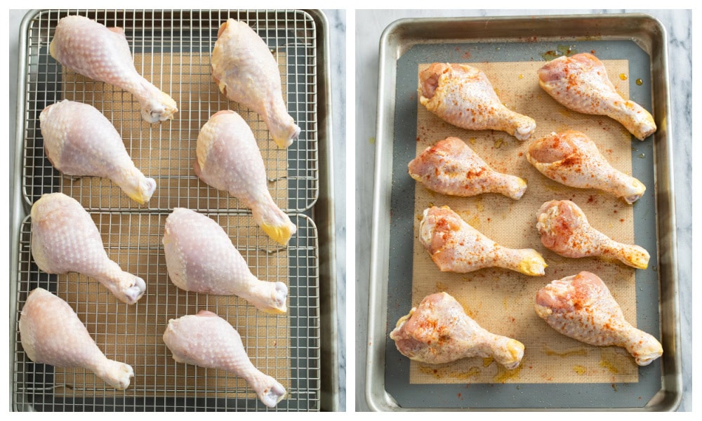 Chicken Drumsticks being dry brined on cooling racks next to a baking sheet of uncooked drumsticks.