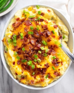 Overhead view of Loaded Mashed Potatoes with cheese, bacon, and green onions.